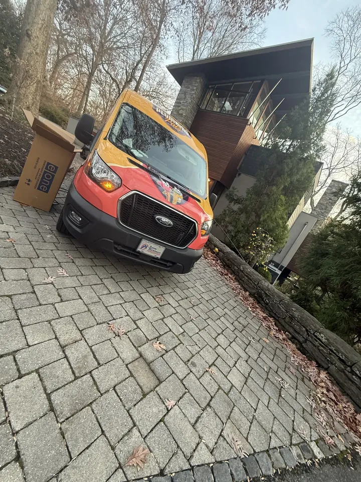 Wrapped Plumbing Pals Transit van parked in a residential driveway