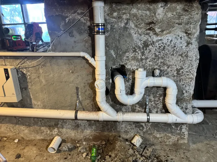 New PVC drain and stack piping installed in a basement