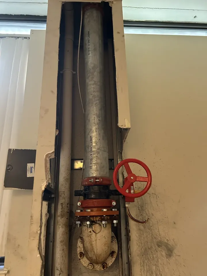 Large commercial water main with a red gate valve