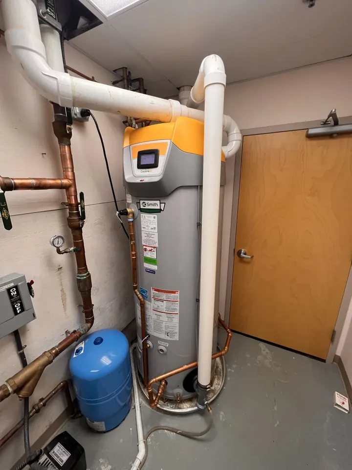 A. O. Smith Cyclone Mxi commercial condensing water heater with PVC venting and an expansion tank