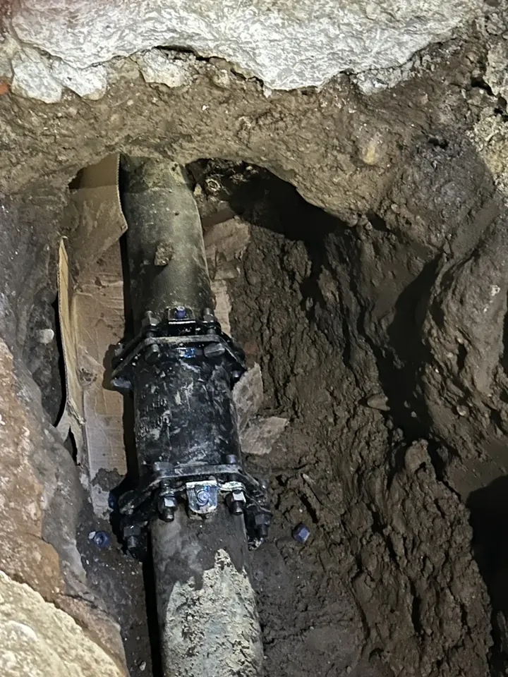 A 6-inch water line connection exposed in an open excavation