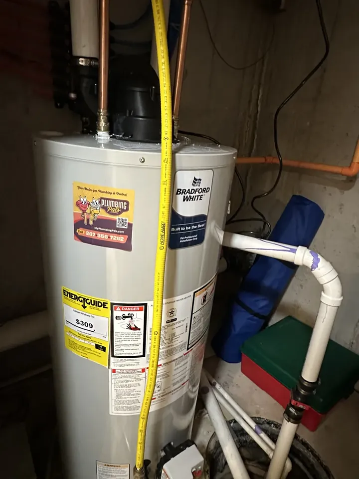 Bradford White tank water heater with new connections and a Plumbing Pals sticker