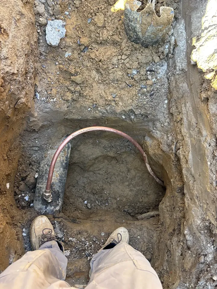 Copper gooseneck tap connecting a new water service to the city water main